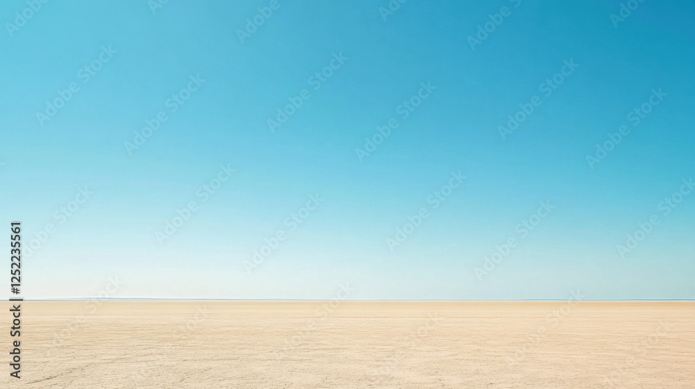 Naklejka premium Vast Desert Landscape Under Clear Blue Sky with Soft Horizon