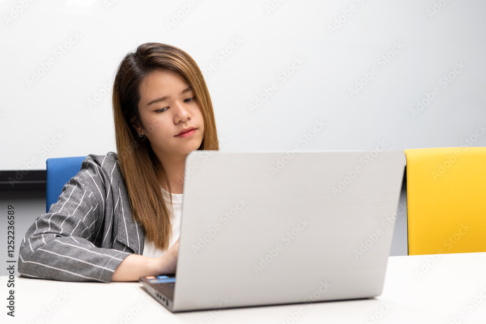Woman working by laptop in office with happy Woman working by laptop in office with happy