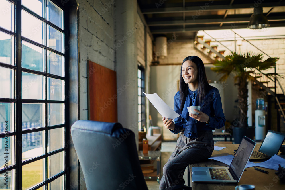 Fototapeta premium Young woman working in an office