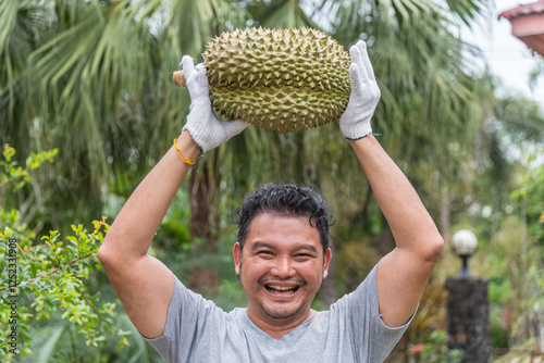 Asian farmer holding Durian is a king of fruit photo