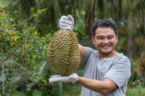 Asian farmer holding Durian is a king of fruit photo