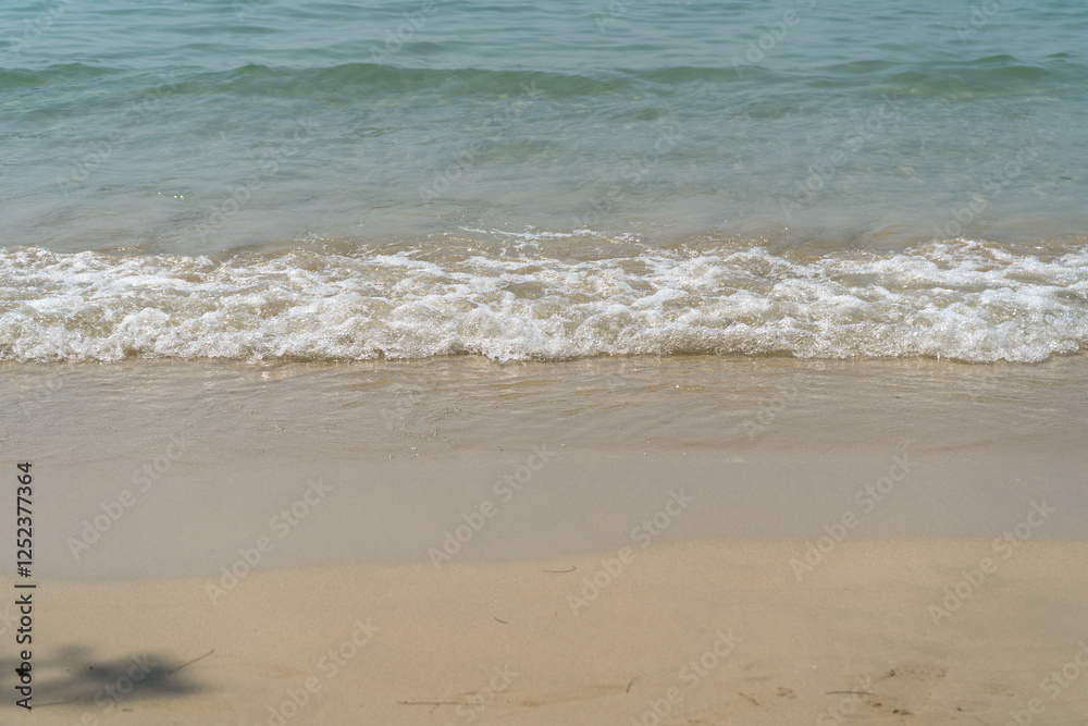 Summer waves crash on the sandy beach Summer waves crash on the sandy beach