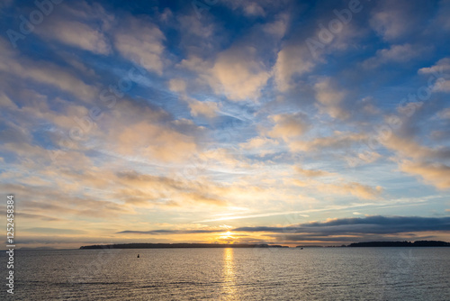 Scenic Sunset Over the Ocean with Vibrant Clouds and Serene Horizon