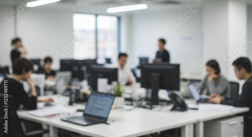 This image depicts a blurred office environment with multiple desks and computers, highlighting the workspace setup and overhead lighting