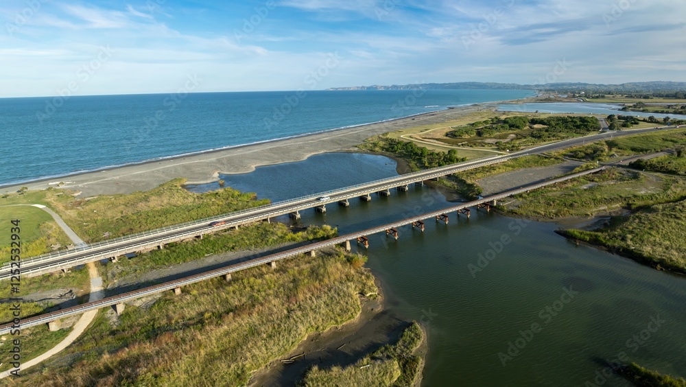 Obraz premium Aerial view of multiple bridges crossing a waterway, connecting the ocean to a bay. Coastal landscape. Clive, Napier, Hawke's Bay, New Zealand