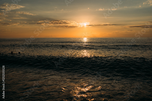 Powerful ocean waves crashing on the shore at sunset
