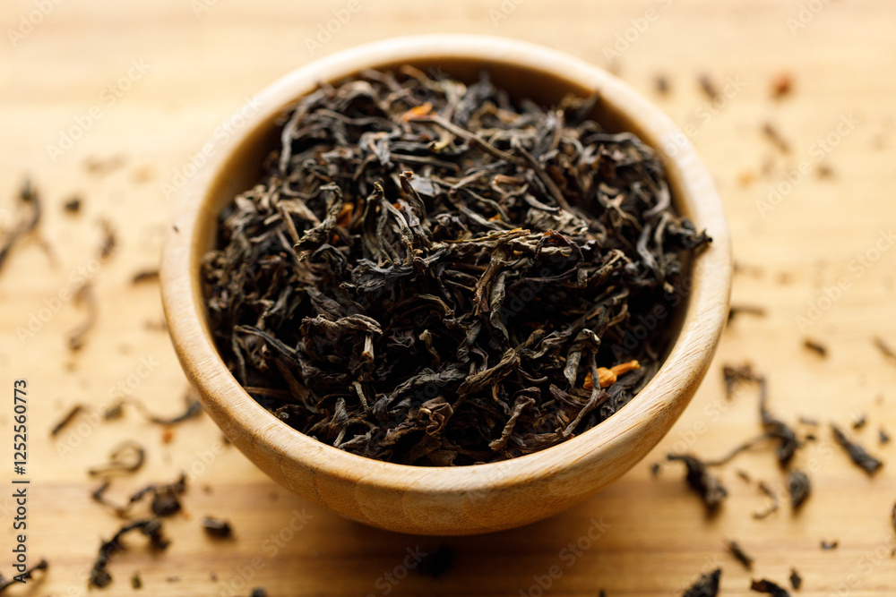 Japanese or Chinese jasmine tea leaf in wooden bowl on wooden background. Japanese or Chinese jasmine tea leaf in wooden bowl on wooden background.