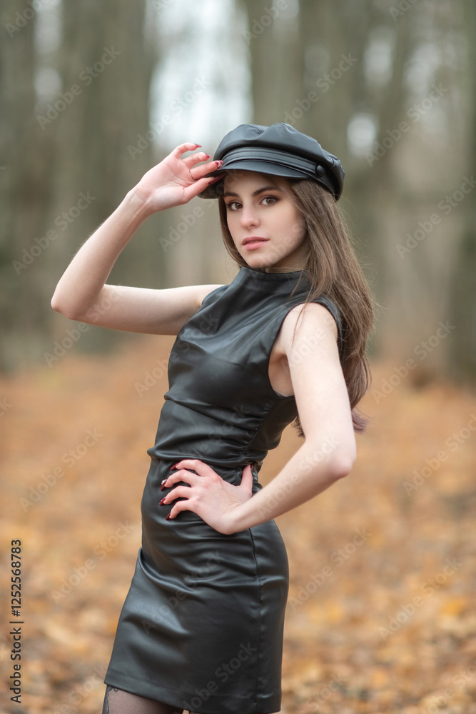 Portrait of a young beautiful brown-eyed long-haired girl in a black dress in nature. Portrait of a young beautiful brown-eyed long-haired girl in a black dress in nature.