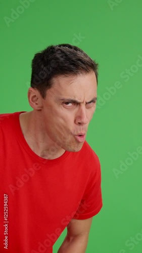 Smiling man appearing and pointing at the copy space.