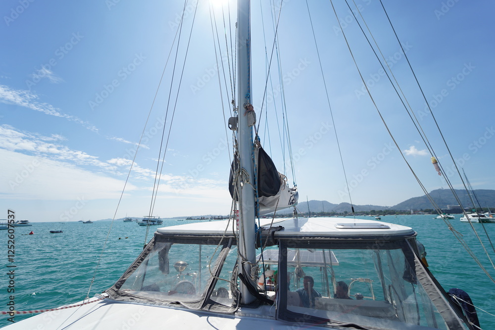 Fototapeta premium A white voyage boat featuring a steering wheel floating in the water