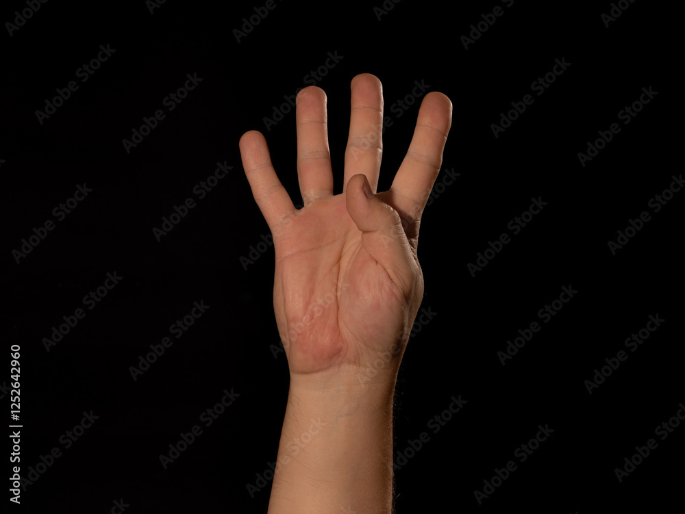 A hand with four fingers is raised A hand with four fingers is raised