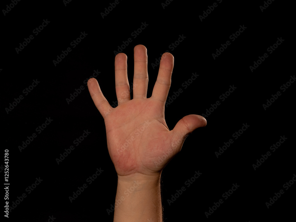 A hand with five fingers is raised A hand with five fingers is raised