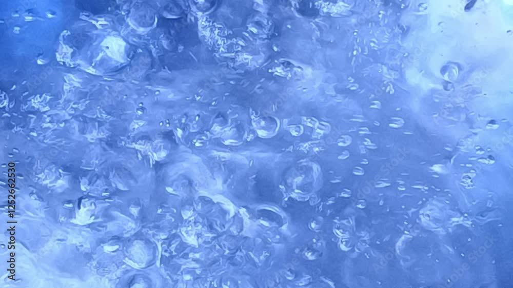 Closeups of bubbles forming and rising highlighting the dynamic transformation of water as it heats Closeups of bubbles forming and rising highlighting the dynamic transformation of water as it heats