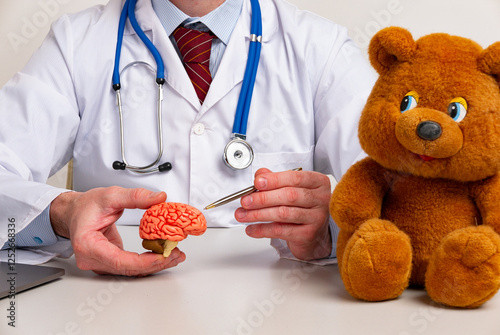 doctor is pointing pen anatomical model human brain. Help and care concept photo