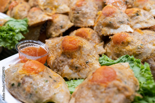 A mix of crab and chicken served inside crab shells with chilli sauce. The shells are filled with a flavorful combination of tender crab meat and succulent chicken,creating a delicious and unique dish