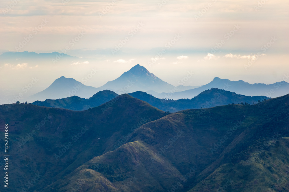 Majestic view of Kodaikanal mountains during early morning with soft clouds in the sky Majestic view of Kodaikanal mountains during early morning with soft clouds in the sky