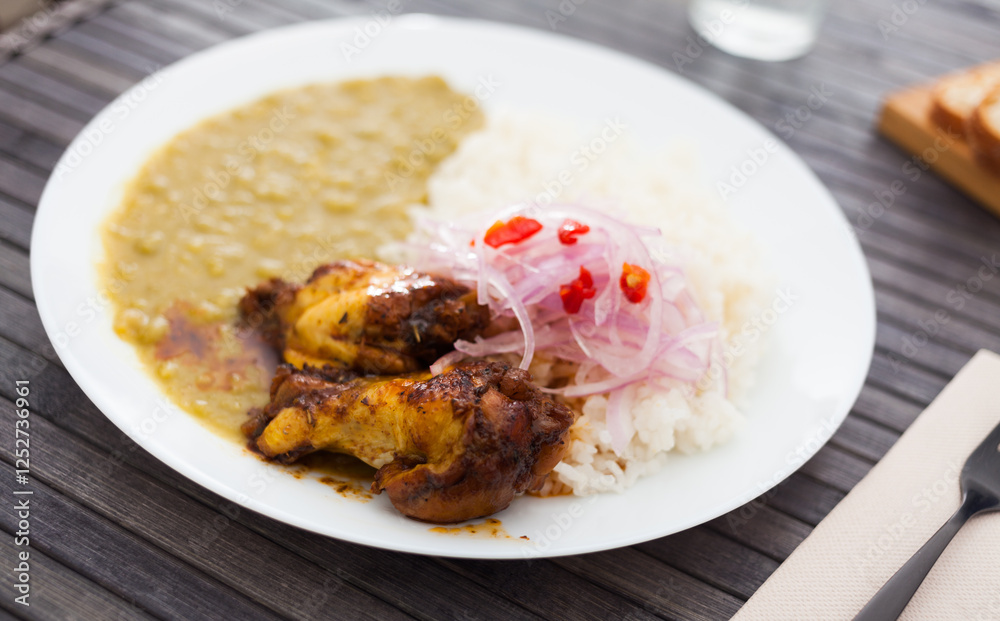 Peruvian dish. chicken wings with pea puree, rice and pickled onions Peruvian dish. chicken wings with pea puree, rice and pickled onions