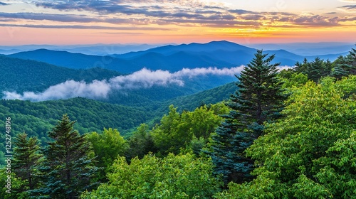 Mountains covered in trees at sunset with cloud layers and colorful sky photo