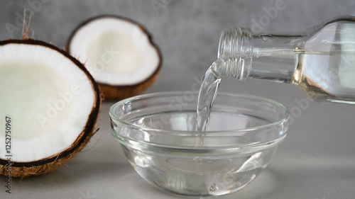Pouring coconut oil in a bowl.