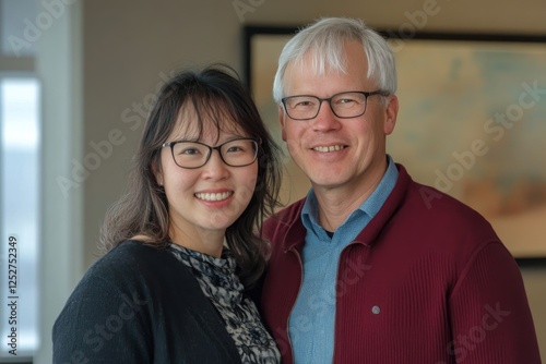 Portrait of a smiling woman and man indoors at a modern setting, showcasing f...