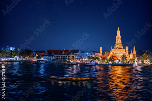 Photography Beautiful night view of Wat Arun ratchawararam with stars, illuminated thai temp