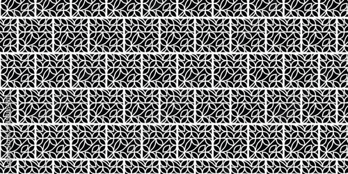 Stylish black and white geometric pattern featuring symmetrical decorative leaf-inspired motifs arranged seamlessly. Perfect for backgrounds, textiles, wallpapers, and design projects requiring intric