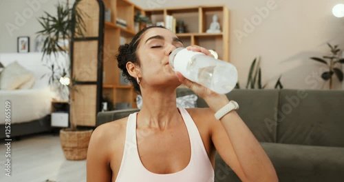 Thirsty, fitness and woman with water, home and break for exercise with hydration, healthy and lounge. Refreshing, rest and person with bottle in living room, wellness and drinking of liquid in house