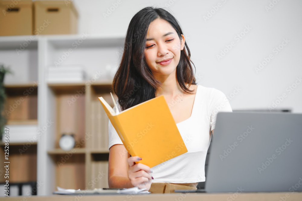 An Asian businesswoman works at her desk office, smiling while analyzing financial data planning business strategies on her laptop to enhance profitability,optimize resources,ensure financial growth An Asian businesswoman works at her desk office, smiling while analyzing financial data planning business strategies on her laptop to enhance profitability,optimize resources,ensure financial growth