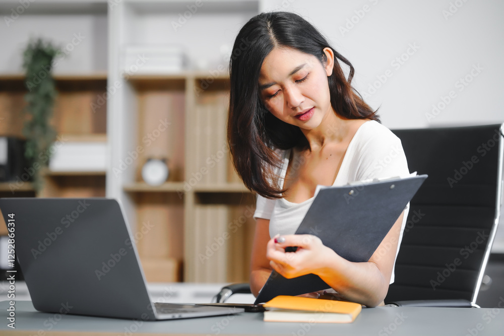 An Asian businesswoman works at her desk office, smiling while analyzing financial data planning business strategies on her laptop to enhance profitability,optimize resources,ensure financial growth An Asian businesswoman works at her desk office, smiling while analyzing financial data planning business strategies on her laptop to enhance profitability,optimize resources,ensure financial growth