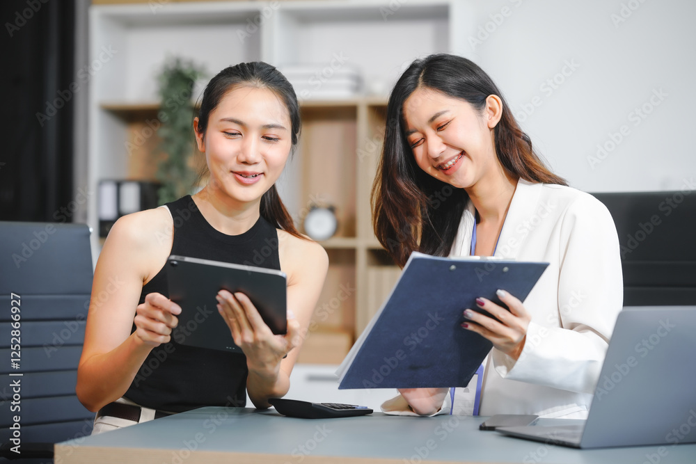Two Asian female business woman sit desk,discussing business investments.They analyze financial data, explore market opportunities, and strategic growth to maximize returns ensure business success Two Asian female business woman sit desk,discussing business investments.They analyze financial data, explore market opportunities, and strategic growth to maximize returns ensure business success