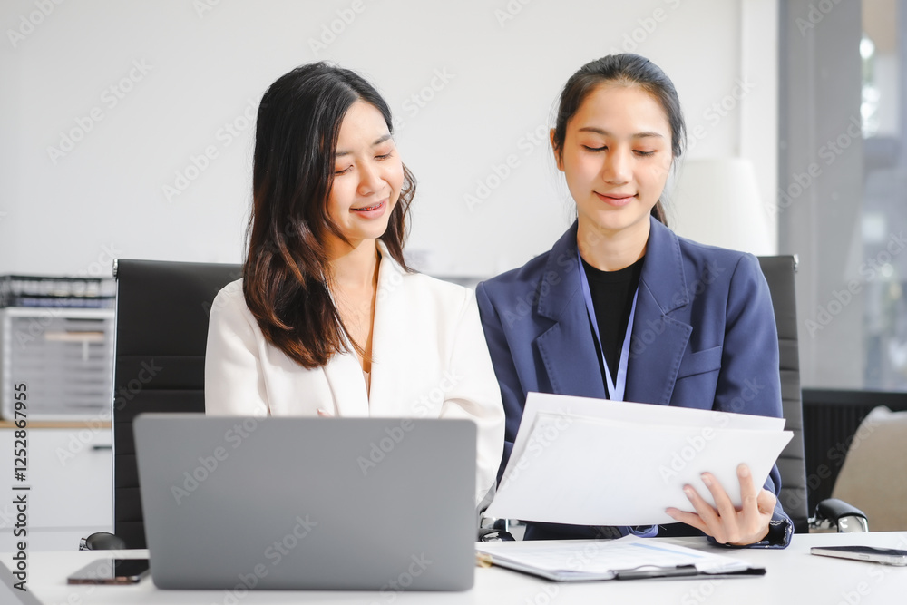 Two Asian female business woman sit desk,discussing business investments.They analyze financial data, explore market opportunities, and strategic growth to maximize returns ensure business success Two Asian female business woman sit desk,discussing business investments.They analyze financial data, explore market opportunities, and strategic growth to maximize returns ensure business success