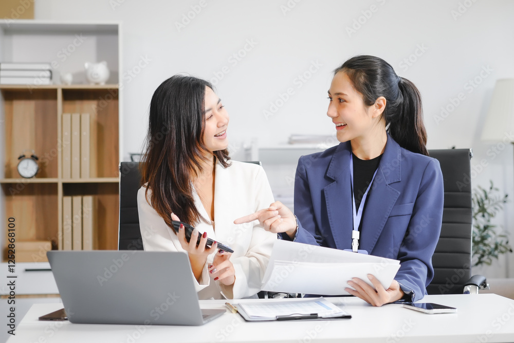 Two Asian female business woman sit desk,discussing business investments.They analyze financial data, explore market opportunities, and strategic growth to maximize returns ensure business success Two Asian female business woman sit desk,discussing business investments.They analyze financial data, explore market opportunities, and strategic growth to maximize returns ensure business success