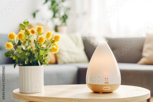 A white diffuser sits on a wooden table next to a potted plant