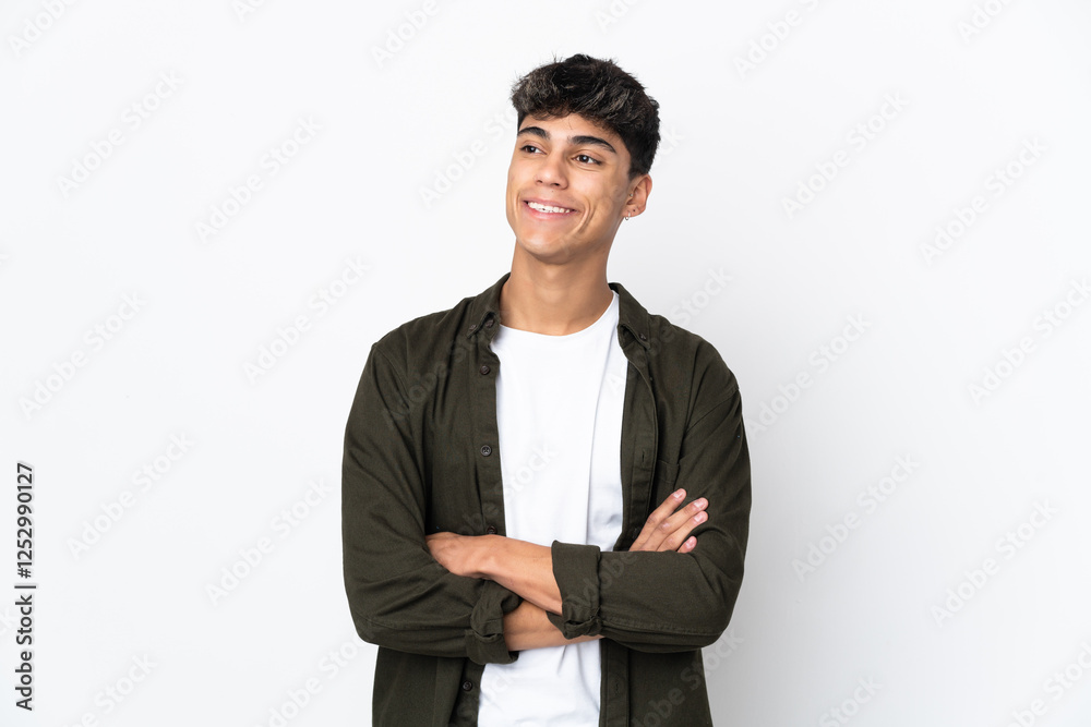 Young man over isolated white background looking up while smiling Young man over isolated white background looking up while smiling