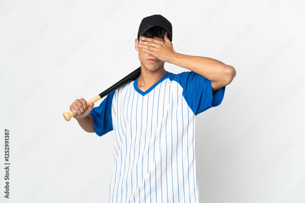 Man playing baseball over isolated white background covering eyes by hands. Do not want to see something Man playing baseball over isolated white background covering eyes by hands. Do not want to see something