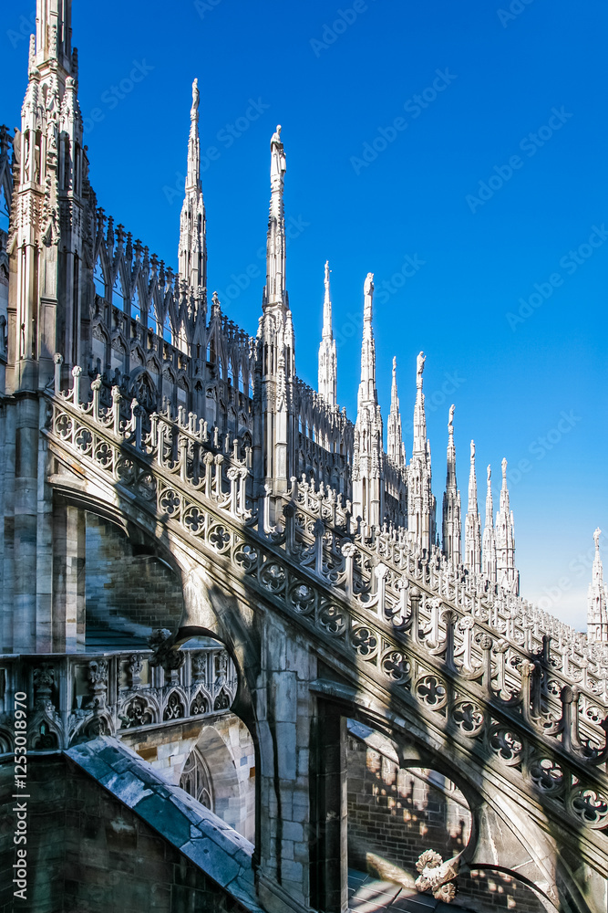 A row of buildings with many statues on the top Duomo in Milano Italy A row of buildings with many statues on the top Duomo in Milano Italy