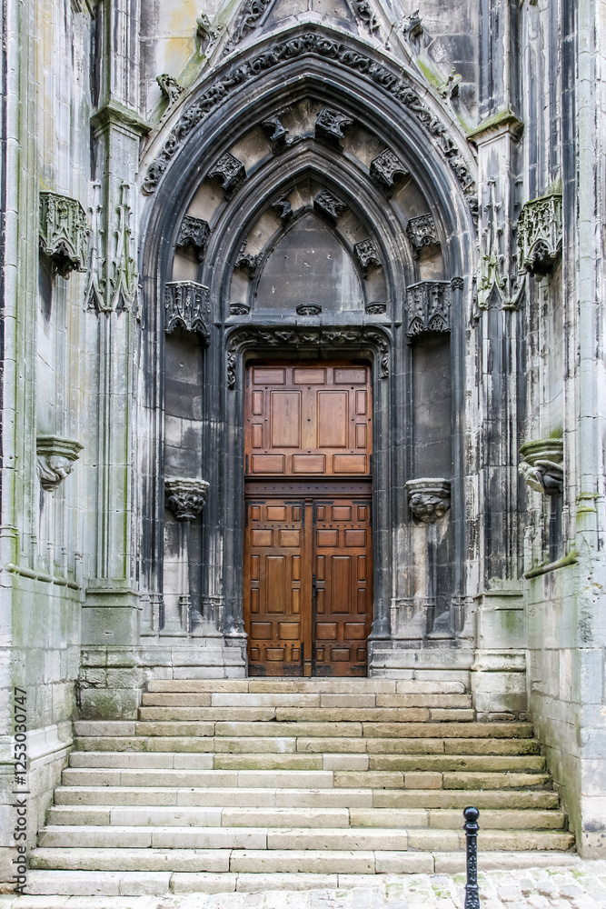 A large archway with a wooden door A large archway with a wooden door