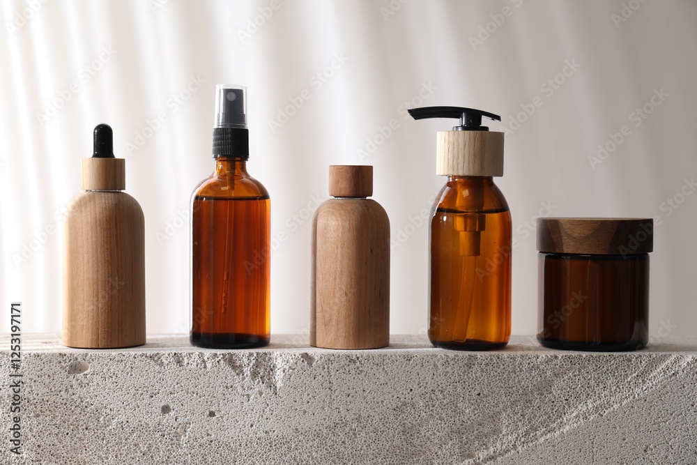 Different cosmetic products on concrete surface against light background Different cosmetic products on concrete surface against light background