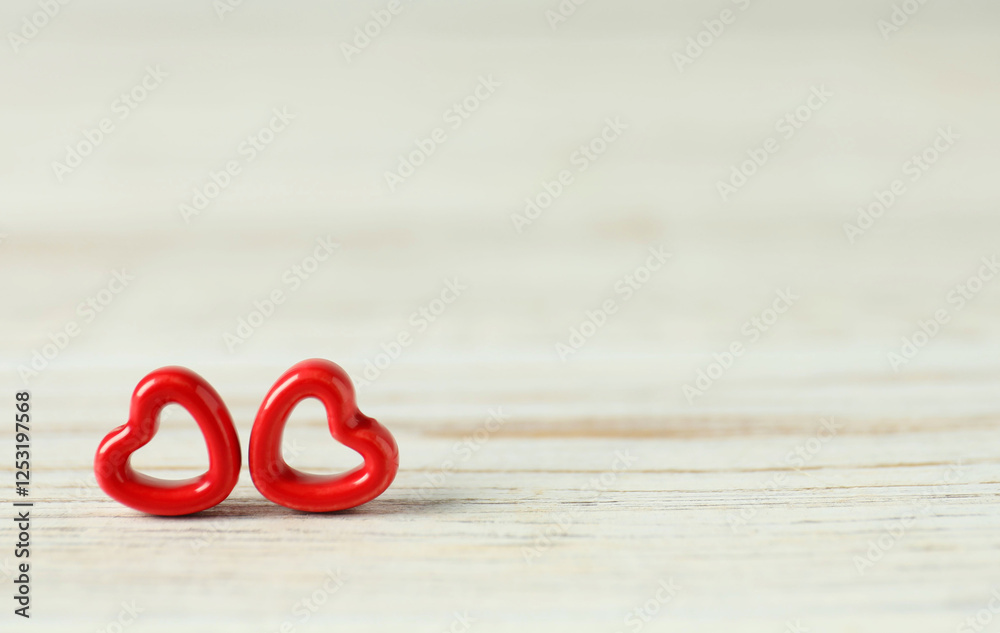 Red decorative hearts on white wooden table, space for text. Happy Valentine's day Red decorative hearts on white wooden table, space for text. Happy Valentine's day