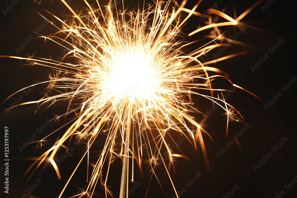 Bright burning sparkler on black background, closeup Bright burning sparkler on black background, closeup