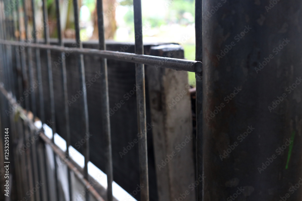 Photo of a house fence made of iron, usually the fence is in front of and surrounds the house Photo of a house fence made of iron, usually the fence is in front of and surrounds the house