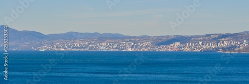 Rijeka, city on Croatian Adriatic sea coastline seen from the Kvarner gulf shoreline and town of Opatija. Third biggest city of Croatia. Croatian town of Rijeka in Kvarner gulf of Adriatic sea.