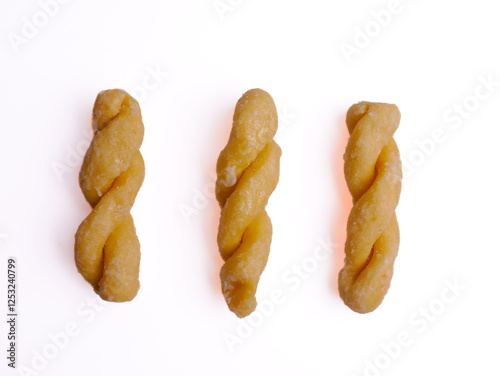 Kue untir-untir or kue tambang isolated on white background, untir untir is a traditional Indonesian deep-fried twisted doughnut that has a sweet and crunchy taste, snack, cookies, crispy, delicious photo