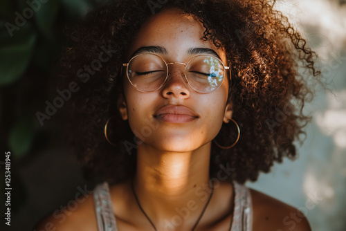 portrait of a beautiful woman with curly hair and glassess 