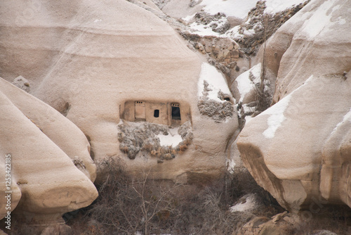 Photos Cappadocia in winter: ancient stone dwellings carved into natural volcanic rocks in the Cappadocian landscape, Turkey