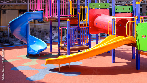 Wallpaper Mural Colorful slide with playground climbing equipment on rubber floor in outdoors playground area at kindergarten Torontodigital.ca