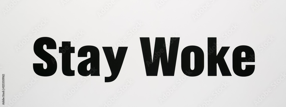 Fototapeta premium Black text 'Stay Woke' on a plain white background, emphasizing awareness and social consciousness.