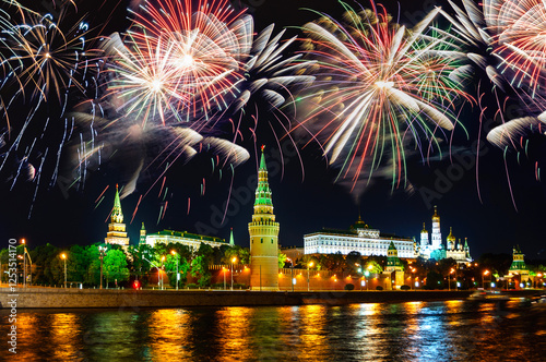 Moscow Kremlin in Russia, night view with festive fireworks in the night sky. Fireworks over Moscow Kremlin Russia, colorful night view of Moscow Kremlin towers on the bank of the Moscow river photo