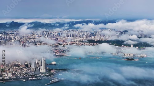 4k aerial video showcasing the unique charm of Qingdao's coastline and urban landscape amidst clouds