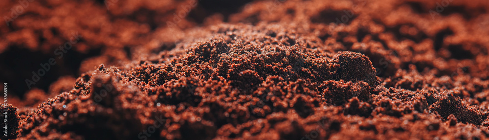 Close-up view of coffee grounds showcasing fine texture and rich colors for vibrant background Close-up view of coffee grounds showcasing fine texture and rich colors for vibrant background